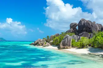 Anse Source d’Argent is famous for&nbsp;luscious coconut palm trees and granite boulders