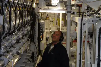Sean in AZZAM's engine room during sea trials