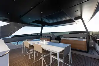 The sun deck has a flybridge forward and dining beneath the hardtop's louvred sunroof