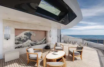 Aft on the main deck is an intimate lounge with a waterfall running down the mosaic mural