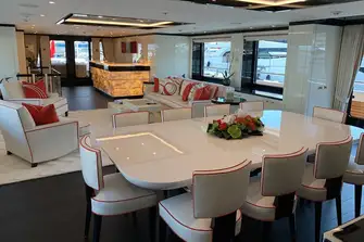 Looking aft in the main saloon with the port balcony's teak decking just visible in the right of shot