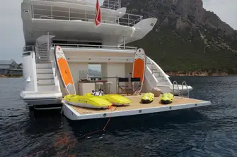 The beach club is aft of the yacht's tender and toy garage