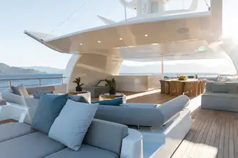 Dining and a fully equipped bar under the spacious sun deck's hardtop, seating forward, sun lounge and sunpads aft